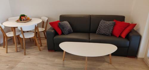 een woonkamer met een bank en een tafel bij Vila Mojca - Studio 13 in Kranjska Gora
