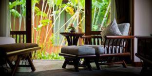 a living room with a couch and a chair and a window at Sibsan Resort & Spa Maetaeng Chiang Mai in Mae Taeng