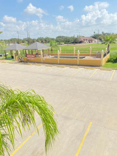 a parking lot with a restaurant in a park at Weslaco Inn - Weslaco/Mercedes in Weslaco