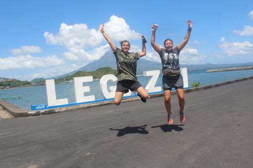 two people jumping in the middle of a road at Maraño's Home in Legazpi