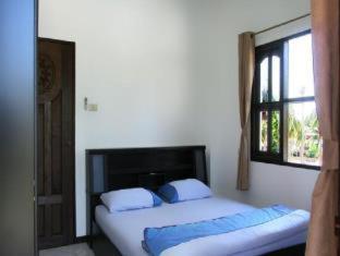 Postel nebo postele na pokoji v ubytování Baan Jasmin Village