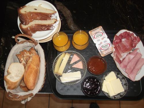 a tray of different types of food on a table at Gite les Rosiers in Traubach-le-Bas