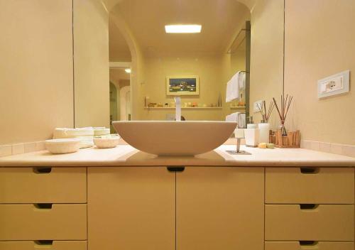 a bathroom counter with a sink and a mirror at Villa Mares - sea view, free garage in Rapallo