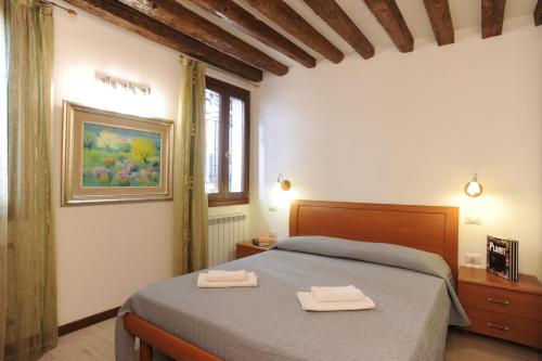 a bedroom with a bed with two towels on it at APPARTAMENTO PARADISO CA' GIULIA in Venice