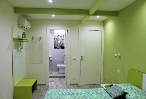 a bedroom with a bed and a bathroom with a toilet at Anima Migrante in Naples