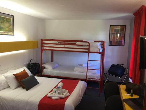 a room with two bunk beds with a phone on top at Quick Palace Poitiers in Chasseneuil-du-Poitou