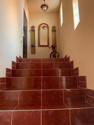a set of brown stairs with a mirror at Casa B&D Residence in Deva