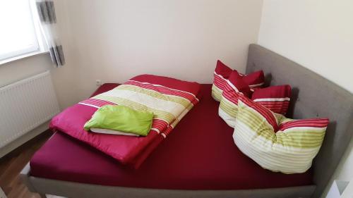 a bed with three pillows on top of it at Ferienwohnung Smillenzweg mit Garten in Lohme