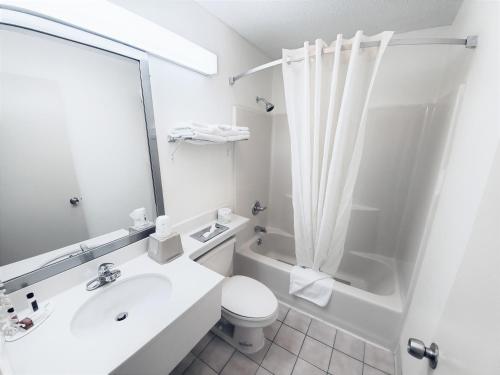 a bathroom with a sink and a toilet and a shower at Super 8 by Wyndham Monticello in Monticello