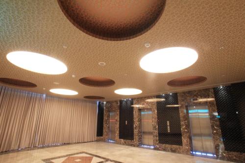 a room with several lights on the ceiling at Yoai Hotel in Yilan City