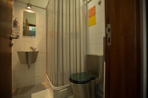 a bathroom with a shower and a toilet and a sink at HI Lisboa - Pousada de Juventude in Lisbon