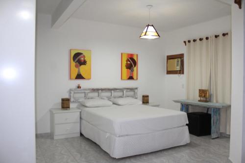 En eller flere senger på et rom på Condominio Sao Cristovao