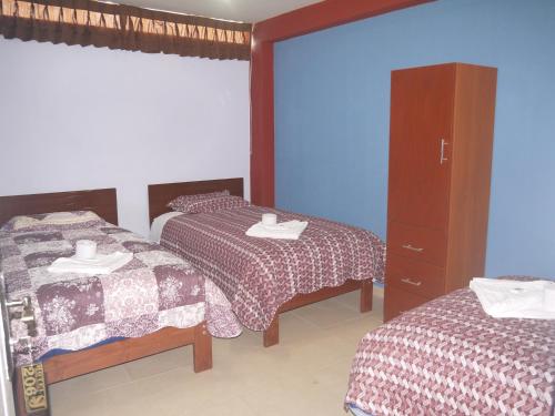 Postel nebo postele na pokoji v ubytování Hotel Suite Juliaca