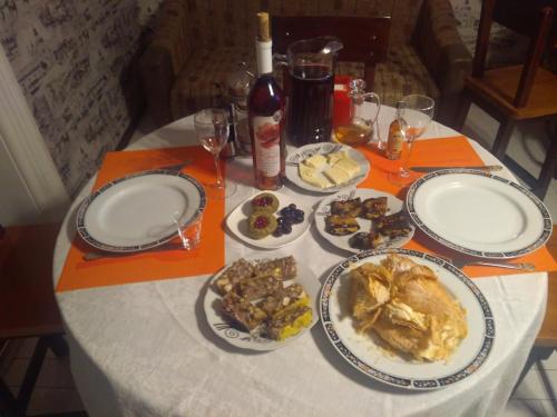 a table with plates of food and glasses of wine at Mia B&B Old Tbilisi in Tbilisi City