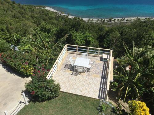 an aerial view of a patio with a table and chairs at Ocean View Villas in Jost Van Dyke