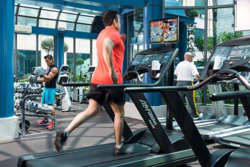 a man running on a treadmill in a gym at Hotel Marquis Reforma in Mexico City