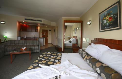 a hotel room with a bed and a living room at Royal Court Hotel in Ramallah