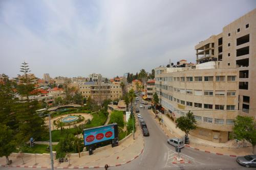 a view of a city with a street and buildings at Royal Court Hotel in Ramallah