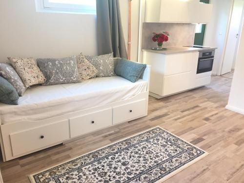 a living room with a couch and a kitchen at Extraordinary apartment with double shower in Norrahammar