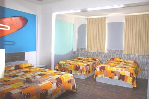 เตียงในห้องที่ Hotel Arrecife Huatulco Plus