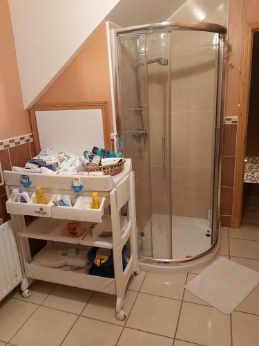 a bathroom with a shower and a crib at Portrush/ballyhome in Portrush
