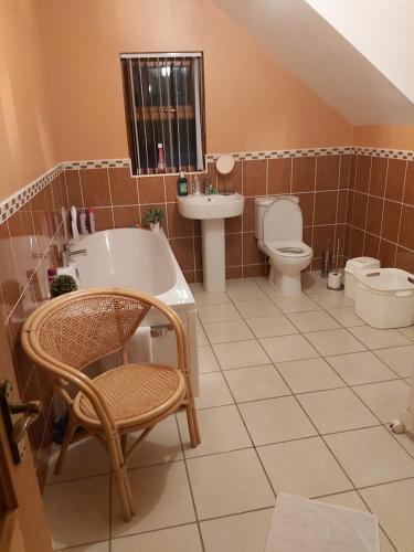 a bathroom with a tub and a toilet and a sink at Portrush/ballyhome in Portrush