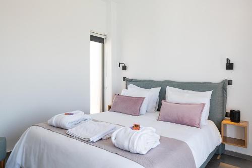 a bedroom with a bed with towels on it at PhantΩm Villas Villa Hero in Kókkinon Khoríon