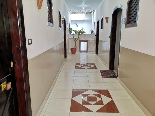 a hallway with a tile floor in a building at Luxor hotel Bella Vista Apartments and Hotel in Luxor