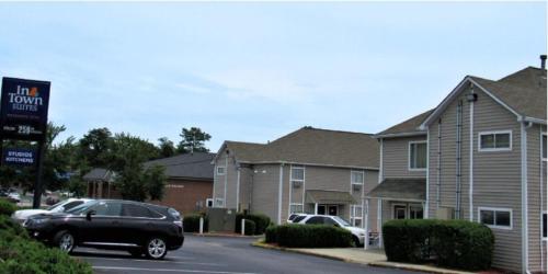 a black car parked in front of a house at InTown Suites Extended Stay Atlanta GA - Forest Park in Forest Park