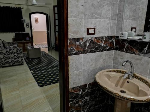 a bathroom with a sink and a mirror at Luxor hotel Bella Vista Apartments and Hotel in Luxor