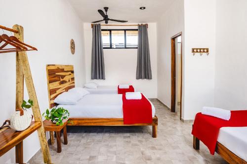 a bedroom with a bed and a dresser at Casa Cuyo Hotel, Restaurant in El Cuyo