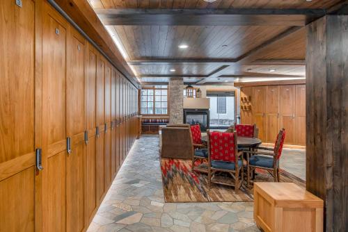 a dining room with wooden walls and a table and chairs at Creekside at Beaver Creek in Beaver Creek