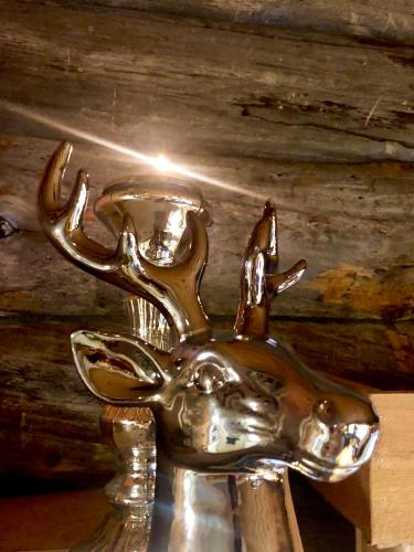 a metal deer head on top of a table at Lapland Lodge Pyhä Ski in, sauna, free WiFi, national park - Lapland Villas in Pyhätunturi