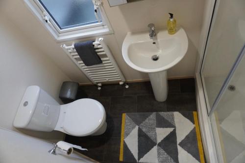 een kleine badkamer met een toilet en een wastafel bij MPoint36 at Tattershall Lakes Hot Tub Lake Views 3 Bedrooms in Tattershall