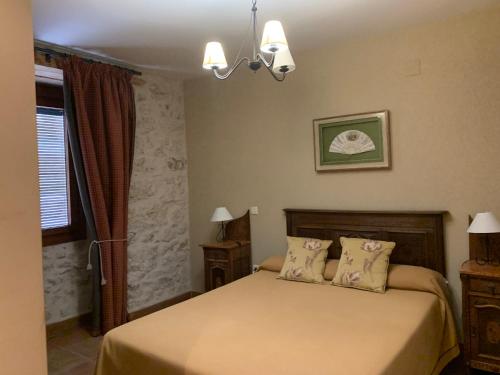 a bedroom with a bed with two pillows at Molino Grande del Duratón in San Miguel de Bernúy