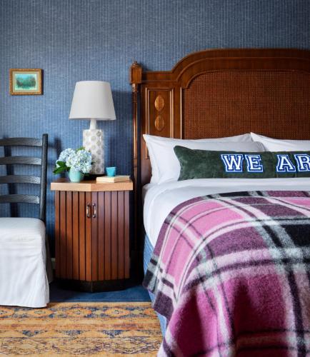 a bedroom with a bed and a table with a lamp at Graduate by Hilton State College in State College