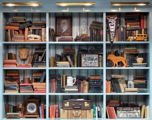 a book shelf filled with lots of books at Graduate by Hilton State College in State College