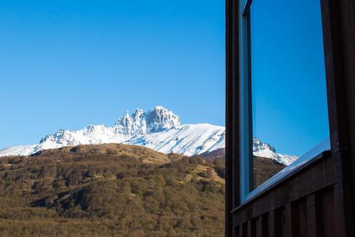 a view of a snow covered mountain from a window at Casa Cerro Castillo in Villa Cerro Castillo