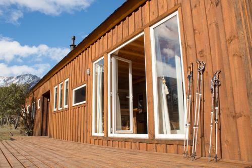 a building with windows and skis on the side of it at Casa Cerro Castillo in Villa Cerro Castillo