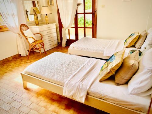 a bedroom with two beds and a dresser at Vravrona Family House in Artemida
