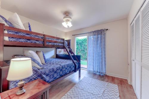 a bedroom with a bed and a window at Tiki Hale in Princeville