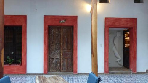 three doors on the side of a building at Hotel Raices de Mar in Mazatlán