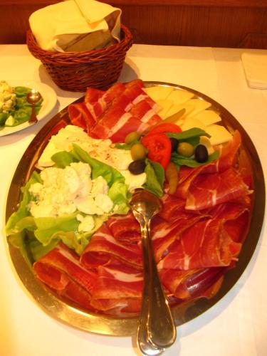 a plate of food on a table with a spoon at Hotel Dina in Međugorje