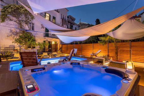 a hot tub in the middle of a patio at Evala luxury rooms with pool and garden in Split