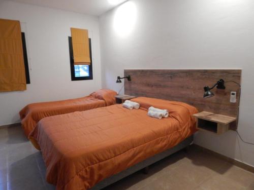 Un pat sau paturi într-o cameră la Departamentos La Rinconada