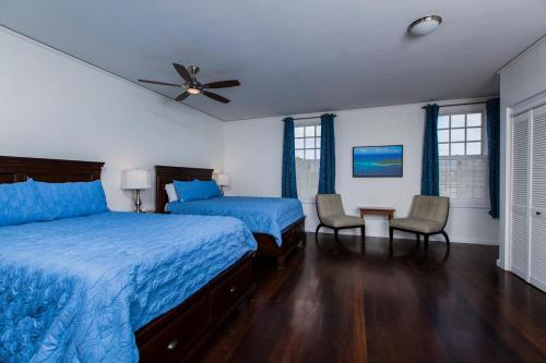a bedroom with two beds and a ceiling fan at Sugar Apple Bed and Breakfast in Christiansted