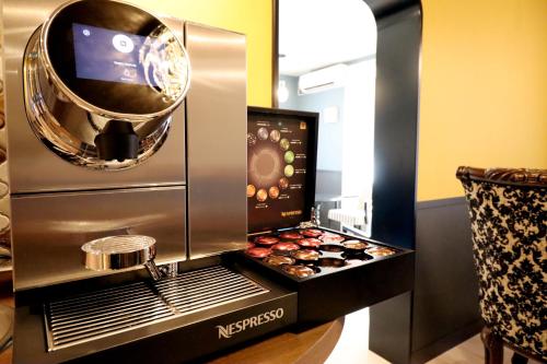 a kitchen with a coffee maker and some pastries at Framboise KYOTO Hotel de charme in Kyoto