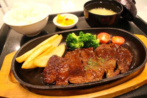 a plate of food with meat and vegetables on a tray at Pal Annex Katsuyama (Love Hotel) in Miyakomachi