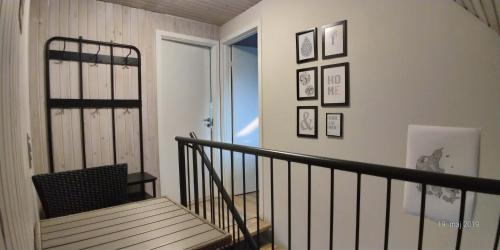 a hallway with a staircase with pictures on the wall at Lenes logi in Herning