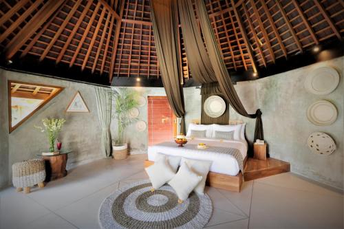 a bedroom with a bed and a table in it at The Sender Pool Suites in Ubud